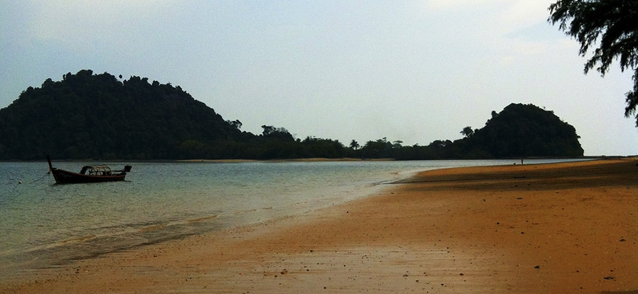 small boat on koh phayam beach